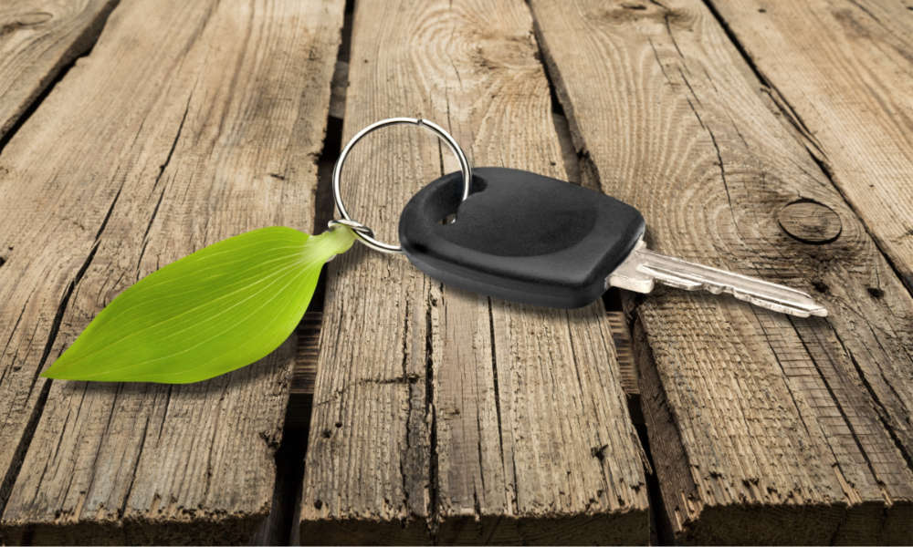 Green Environment - Electric Car Key on the Wooden Floor