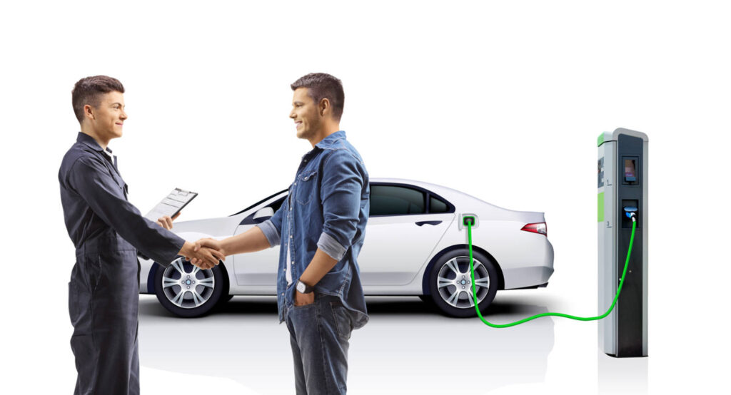 Electric vehicle owner picks up his car from an automotive technician